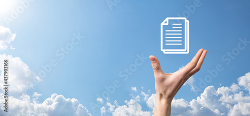 Male hand holding a document icon on blue background. Document Management Data System Business Internet Technology Concept. Corporate data management system DMS