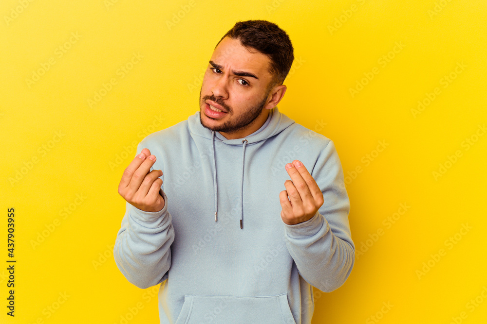 Young caucasian man isolated on yellow background showing that she has no money. Young caucasian man isolated on yellow background showing that she has no money.