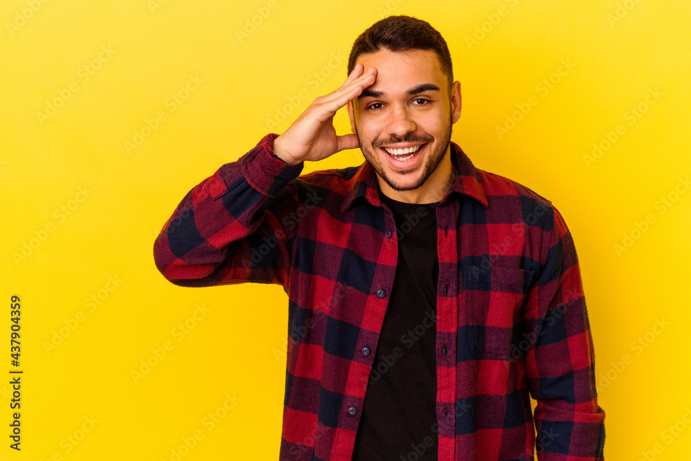 Young caucasian man isolated on yellow background shouts loud, keeps eyes opened and hands tense.