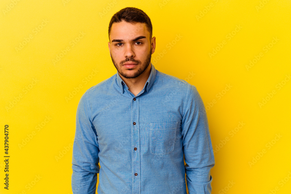 Fototapeta premium Young caucasian man isolated on yellow background sad, serious face, feeling miserable and displeased.