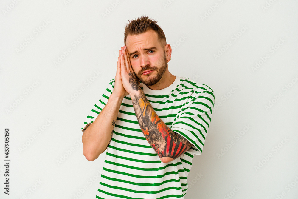 Young tattooed caucasian man isolated on white background yawning showing a tired gesture covering mouth with hand. Young tattooed caucasian man isolated on white background yawning showing a tired gesture covering mouth with hand.