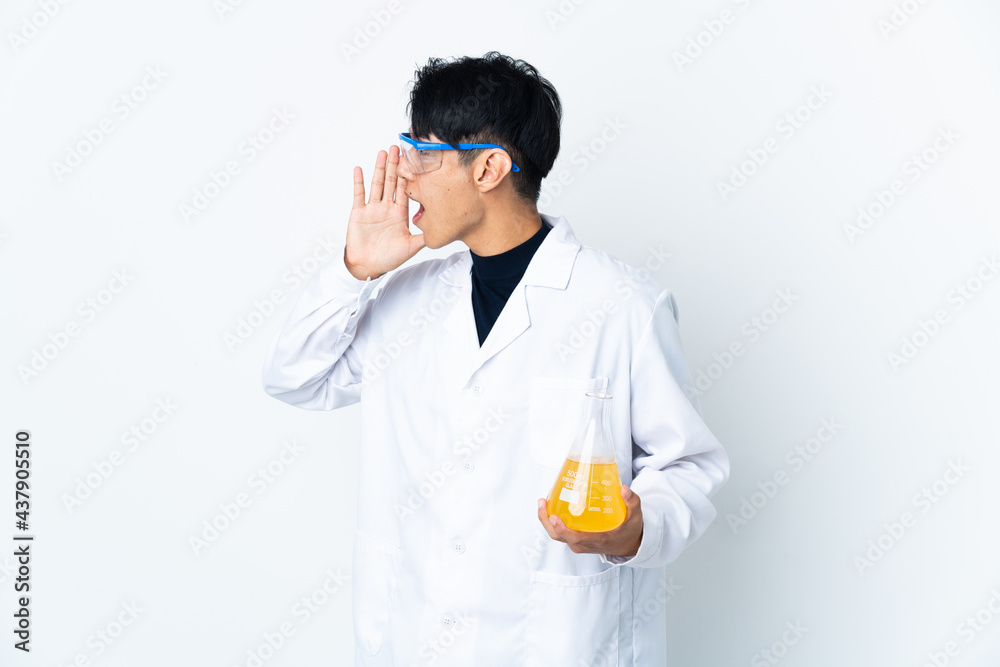 Young Chinese scientific man isolated on white background shouting with mouth wide open to the side Young Chinese scientific man isolated on white background shouting with mouth wide open to the side