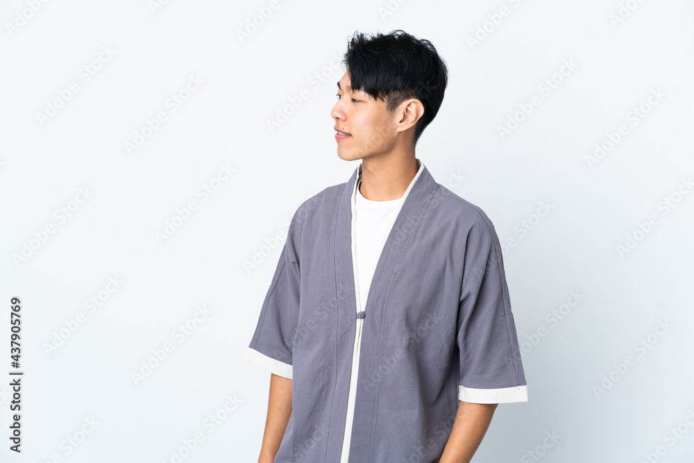 Young Chinese man isolated on white background looking side Young Chinese man isolated on white background looking side
