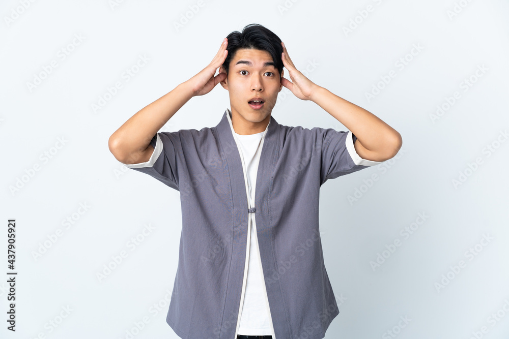 Young Chinese man isolated on white background with surprise expression Young Chinese man isolated on white background with surprise expression