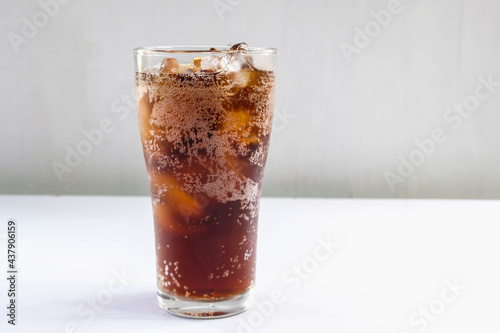 .Glass of soft drinks and black soft drinks on the table