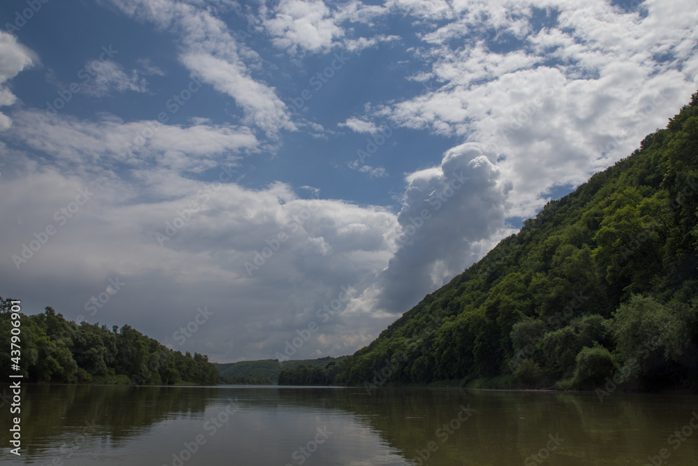 river clouds blue sky and green shores river clouds blue sky and green shores