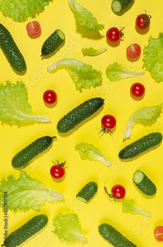 Wallpaper Mural Juicy red tomato, green young cucumber, salad leaves with shadow on yellow background. Modern food pattern, top view, vertical. Torontodigital.ca
