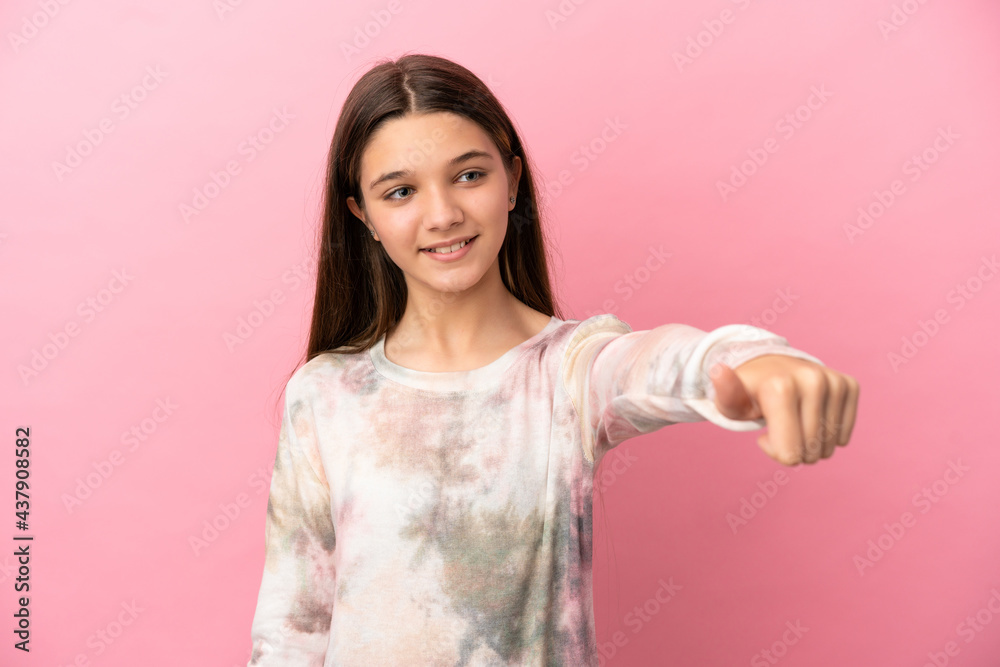 Little girl over isolated pink background giving a thumbs up gesture