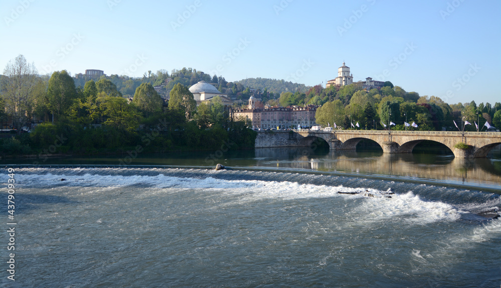 The river Po in Turin photographed by the Murazzi. On the river with the calm and blue waters, the Monte dei Capuccini rises on the Turin hill. The river Po in Turin photographed by the Murazzi. On the river with the calm and blue waters, the Monte dei Capuccini rises on the Turin hill.