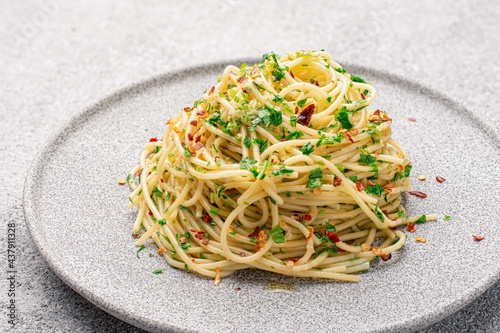 Plate with cooked classic Italian spaghetti aglio olio photo