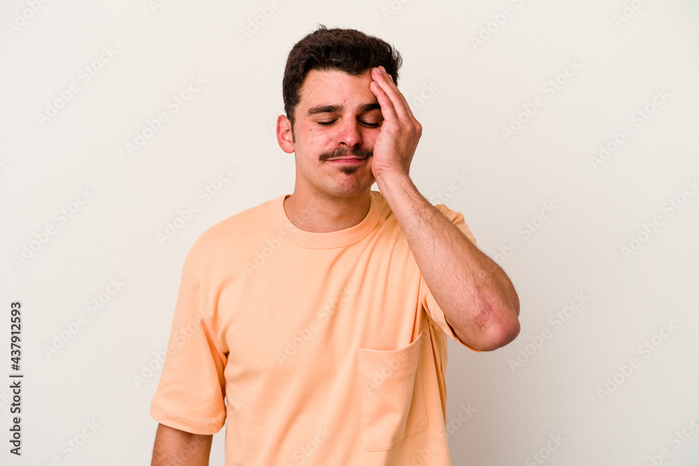 Young caucasian man isolated on white background tired and very sleepy keeping hand on head. Young caucasian man isolated on white background tired and very sleepy keeping hand on head.