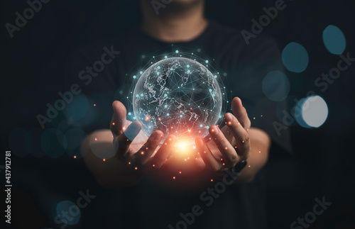 Businessman holding virtual world with orange light and connection line for global telecommunications concept.