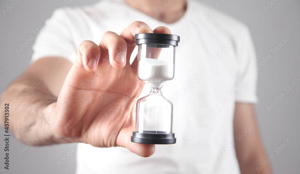 Man holding hourglass. Deadline concept Man holding hourglass. Deadline concept