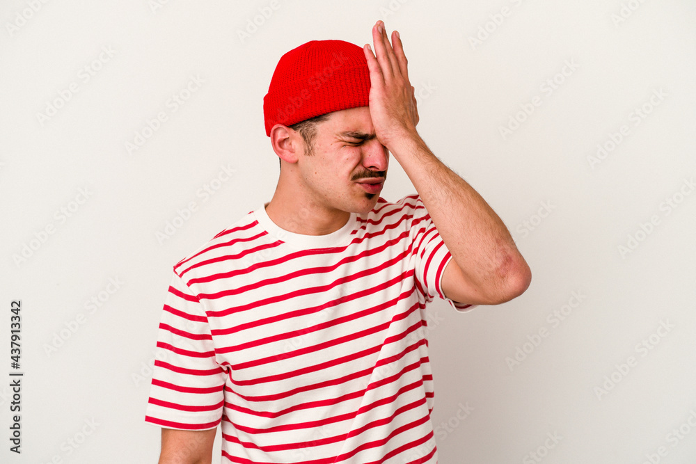 Young caucasian man isolated on white background forgetting something, slapping forehead with palm and closing eyes.