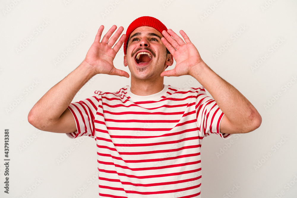 Young caucasian man isolated on white background shouting excited to front.