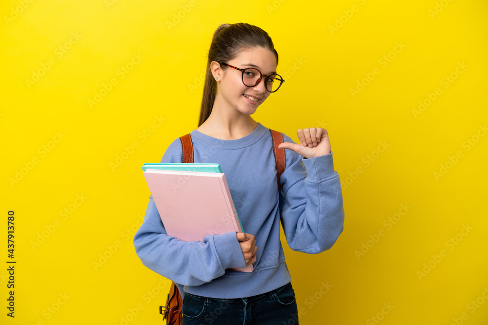 Student kid woman over isolated yellow background proud and self-satisfied Student kid woman over isolated yellow background proud and self-satisfied