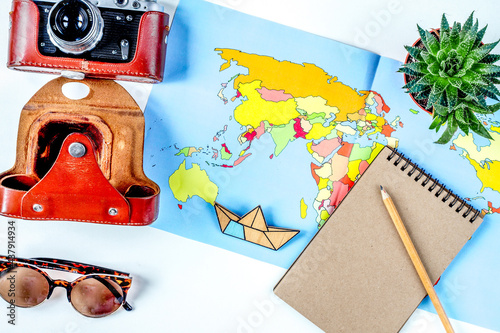 tourist lifestyle with camera and map white table background top view photo