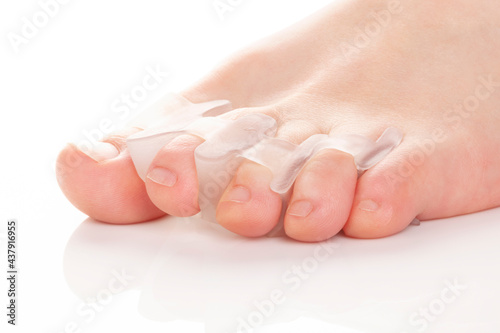 Silicone finger separator. Orthopedic toe corrector on white background. photo