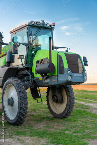 Tractor for spraying pesticides for fertilizers in agriculture. Agricultural sprayer. Agriculture, agricultural machinery. Top dressing of plants. Vertical photo