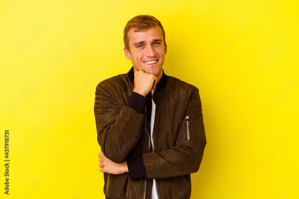 Young caucasian man isolated on yellow background Young caucasian man isolated on yellow background