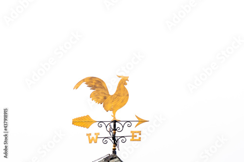 Foto Gold rooster weather vane show the wind direction on white sky background