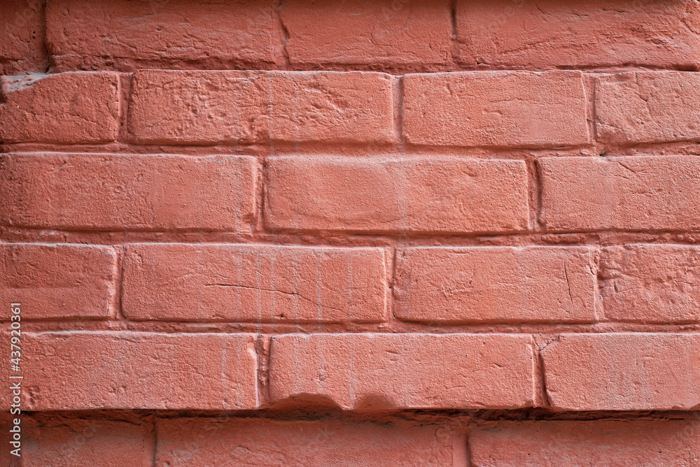 Obraz premium A fragment of a red brick wall. The texture of the stone.