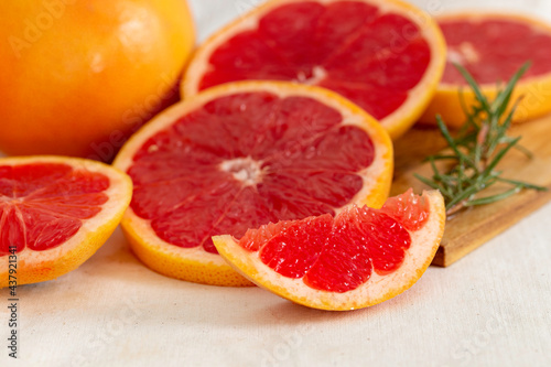 Ripe grapefruit  and slice grapefruit put on wooden tray hand made cloth background.