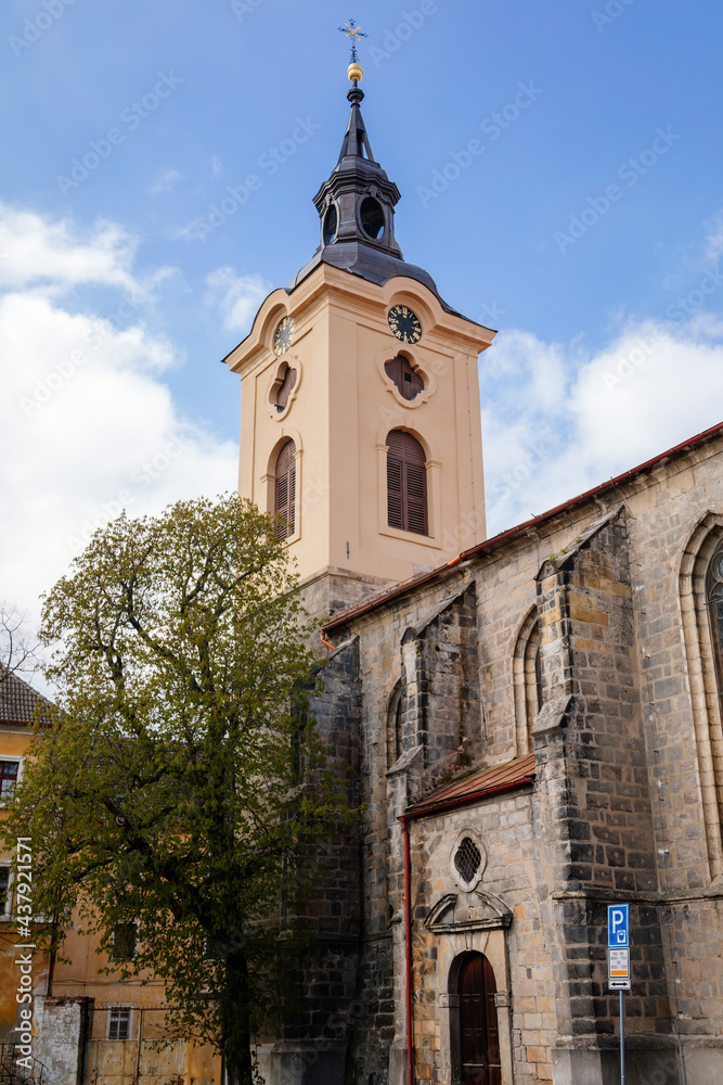 Medieval gothic church of St. Ignatius of Loyola with baroque tower in sunny day, Historical center, gothic arched windows, Bohemian Paradise or Cesky Raj, Jicin, Czech Republic