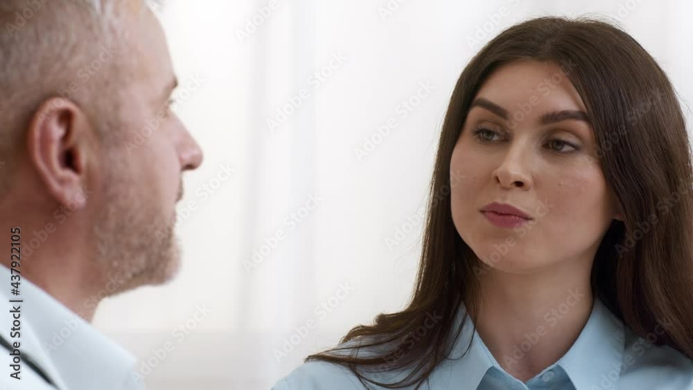 Female Patient Talking With Therapist Complaining About Health In Clinic
