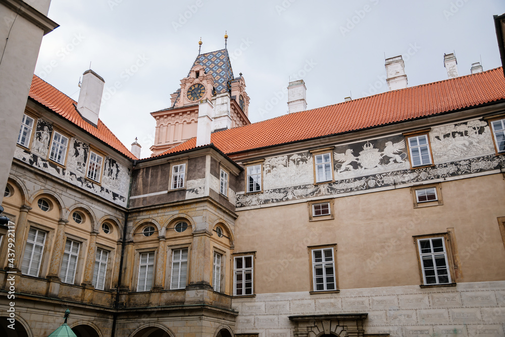 Obraz premium Gothic Castle Brandys nad Labem, Renaissance palace, clock tower, Historical Courtyard with sgraffito mural decorated plaster at facade, wall decor, Central Bohemian, Czech Republic