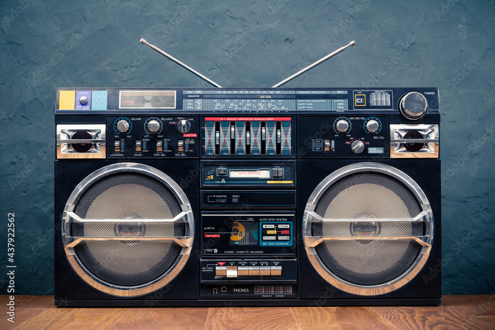 Retro boombox ghetto blaster outdated portable black radio receiver with  cassette recorder from 80s front concrete wall background. Rap, Hip Hop,  R&B music concept. Vintage old style filtered photo Stock 写真