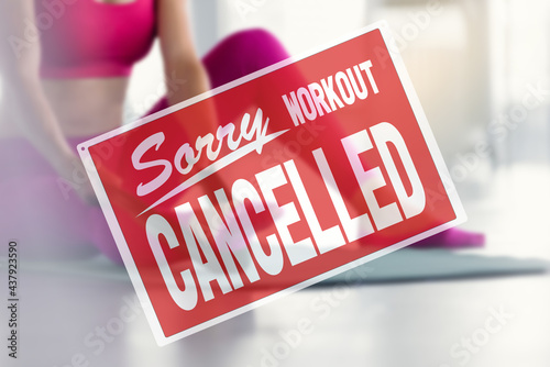 inscription sorry workout canceled. training cancellation due to business closure. part of fit woman doing exercises for legs using strap photo