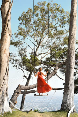 Girl on swing between eucalyptus trees Beverly Hills 