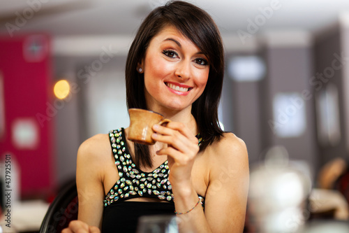 Beautiful woman drinking coffee at the restaurant
