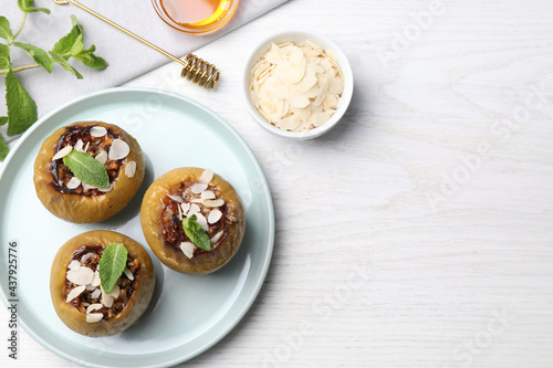 Baked apples on white wooden table, flat lay. Space for text