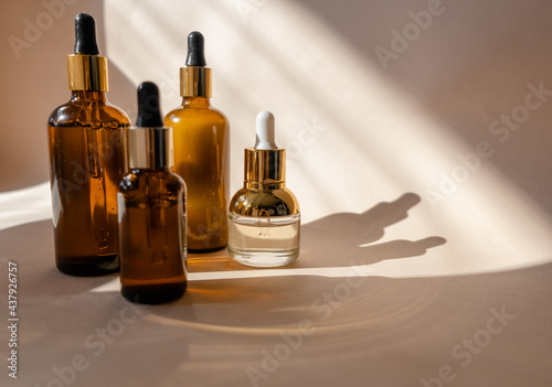 Eco Mineral oil in Amber glass bottles with pipette. Transparent hyaluronic serum gel and skin care concept. Top horizontal view copyspace