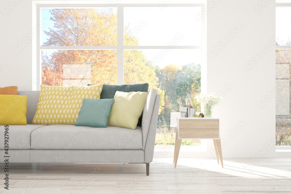 Fototapeta premium Stylish room in white color with sofa and autumn landscape in window. Scandinavian interior design. 3D illustration