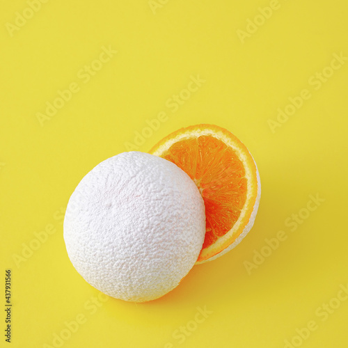 Фототапет Surreal idea of unreal white cut orange fruit on yellow background