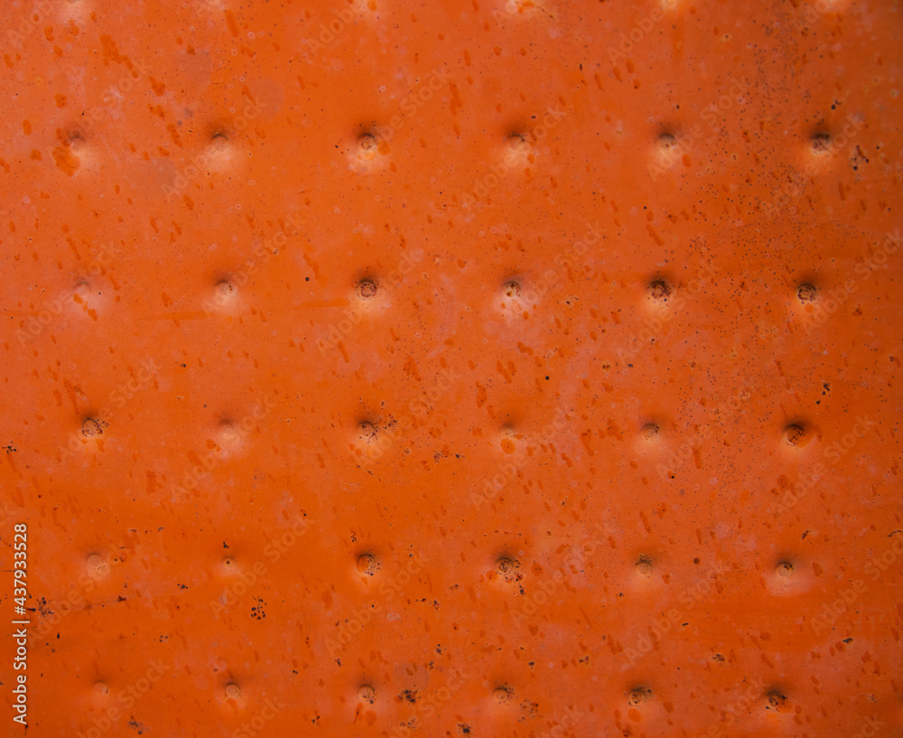 The texture of the metal painted in orange color. Rough and cracked surface. The texture of the metal painted in orange color. Rough and cracked surface.