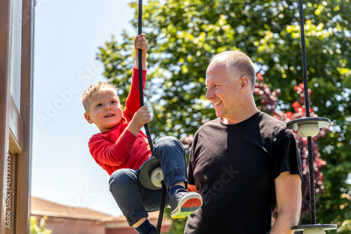 Father playing with his 3 years old son on the playground