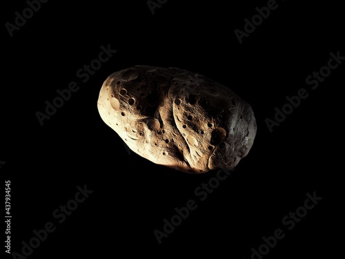 Asteroid isolated on a black background. Craters on the surface of the space stone.  © Nazarii