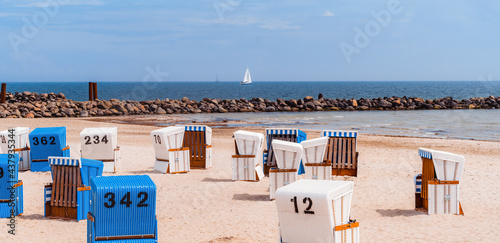 Wicker beach chairs at the beach with sunny weather