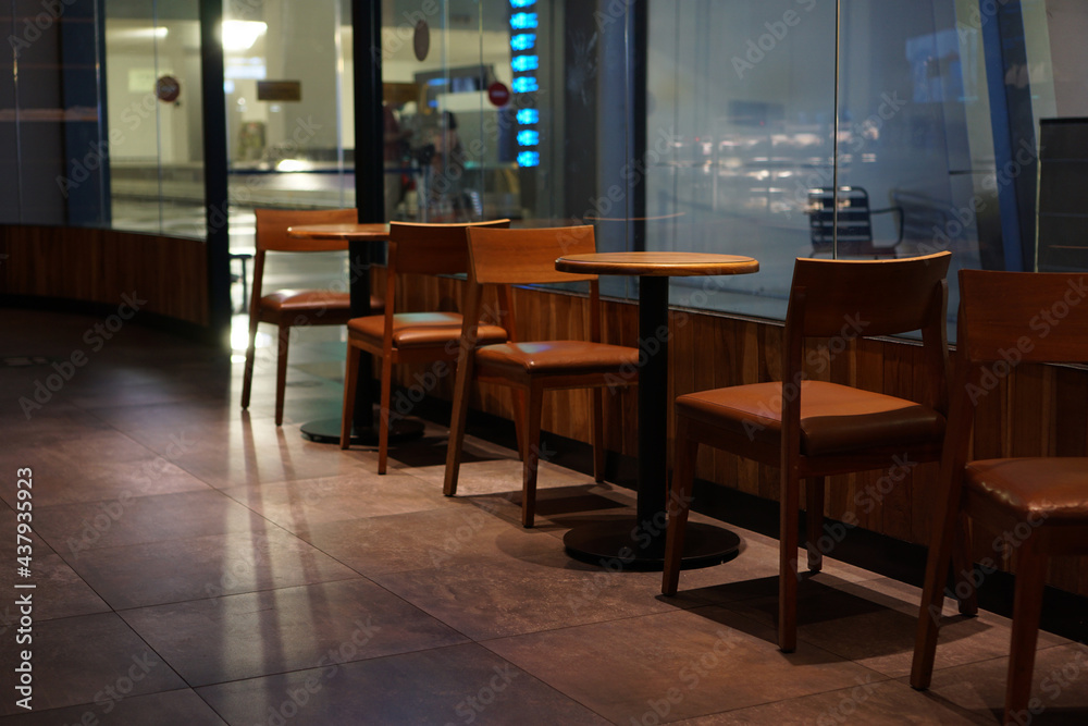 Wooden chairs and tables as part of the interior in a cafe             