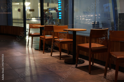 Wooden chairs and tables as part of the interior in a cafe             