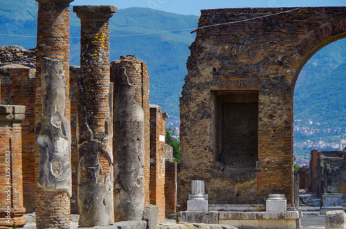 Famous landmark of ancient and historic city temple ruins with columns and walls on archeologic site museum Pompeji Pompeii excavation site in Italy near Naples and Vesuv Volcano photo