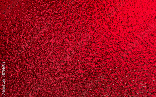 Red shiny foil metallic paper texture background. Use for christmas and valentine day concept.