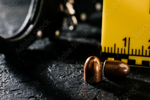 Evidence markers with a knife and a pistol magazine on the ground. A sign of an accident and murder at the scene of the crime. Police theme