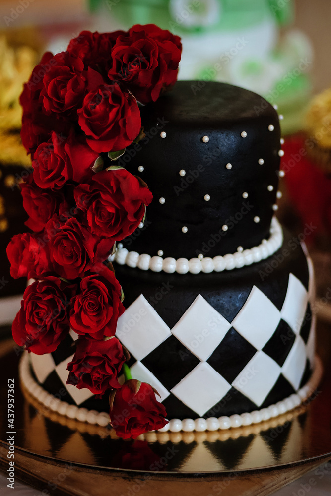 Black birthday cake with roses on candy bar