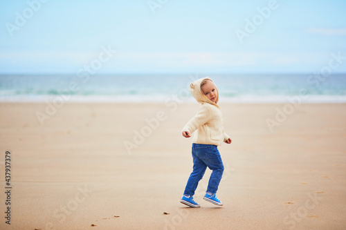 Adorable toddler girl on the sand beach at Atlantic coast of Brittany, France © Ekaterina Pokrovsky