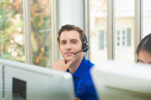 Bilde på lerret Handsome man smile in office,call center service,customer operator helpline serv